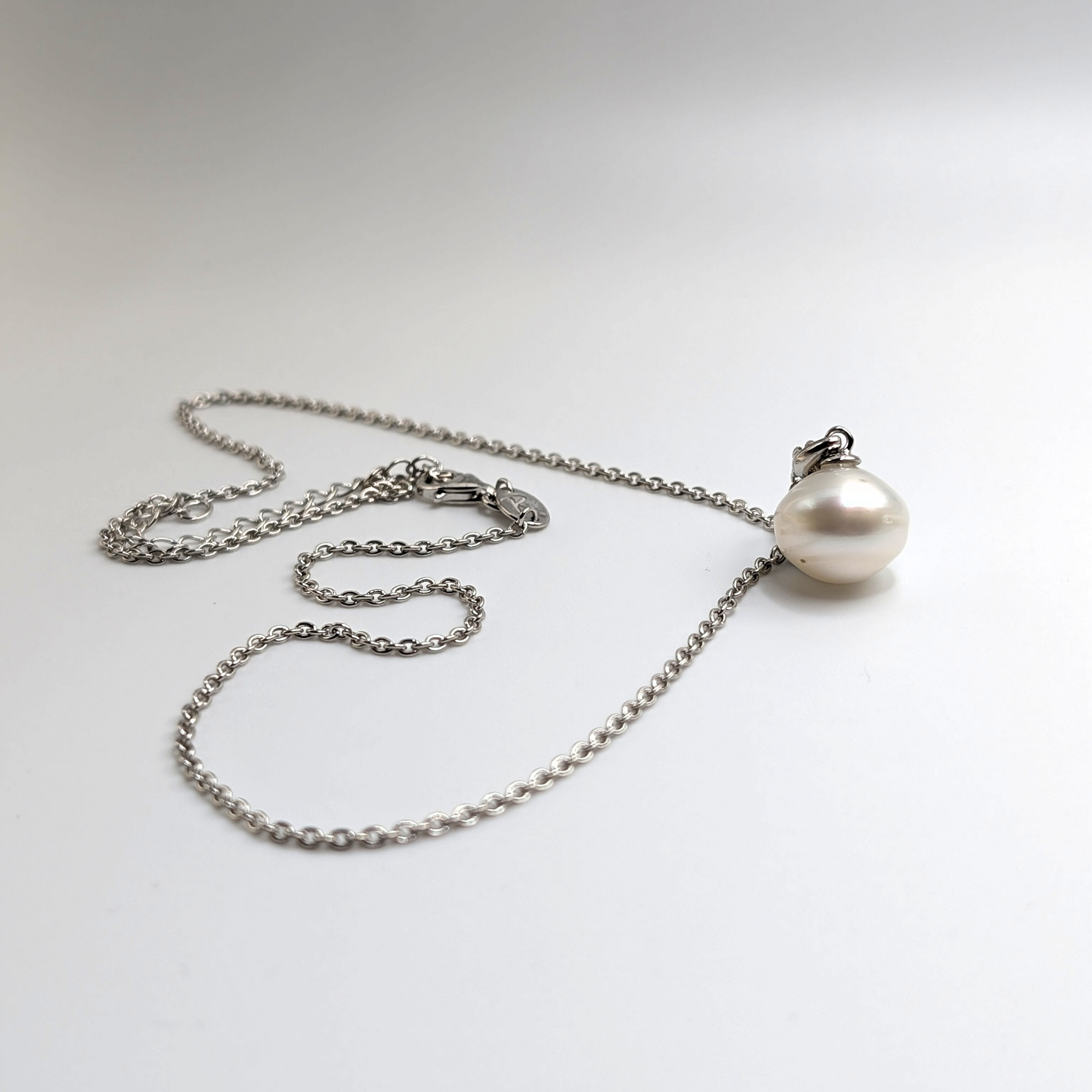 South sea pearl pendant necklace with rhodium plated chain on a white background