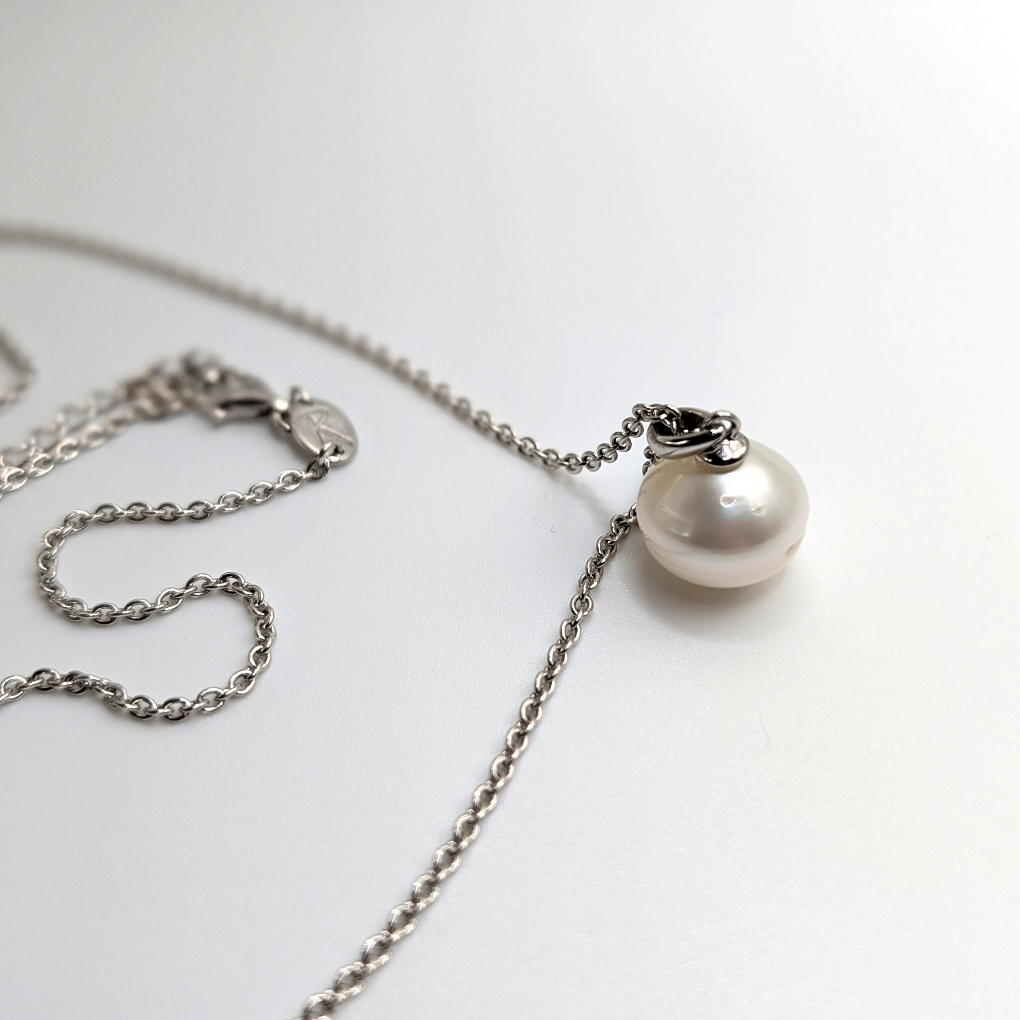 South sea pearl pendant necklace with rhodium plated chain on a white background