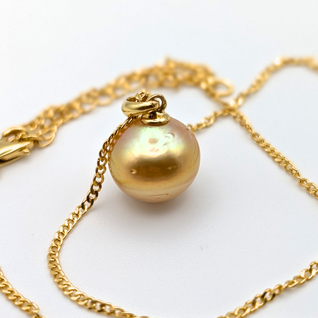 Gold vermeil necklace with an large south sea pearl pendant on a white background
