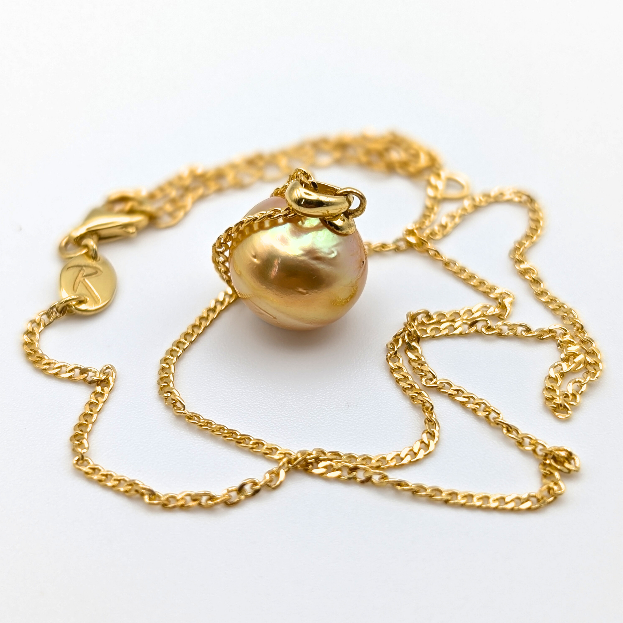Gold vermeil necklace with an large south sea pearl pendant on a white background