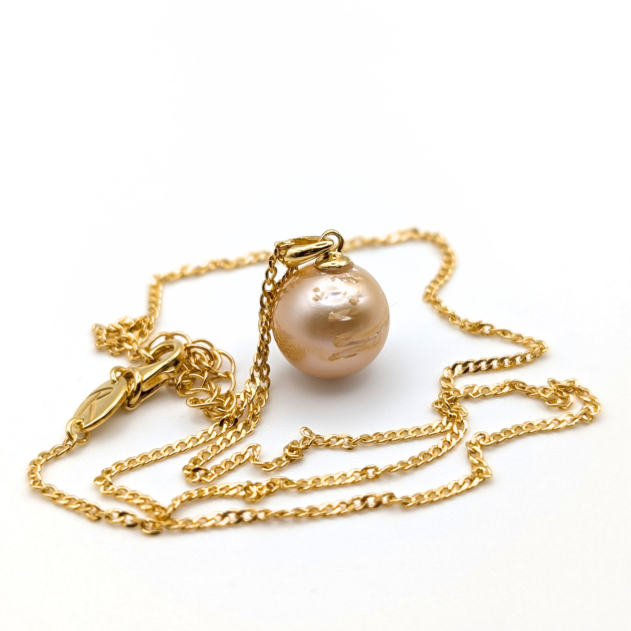 Gold vermeil necklace with a gold south sea pearl pendant on a white background