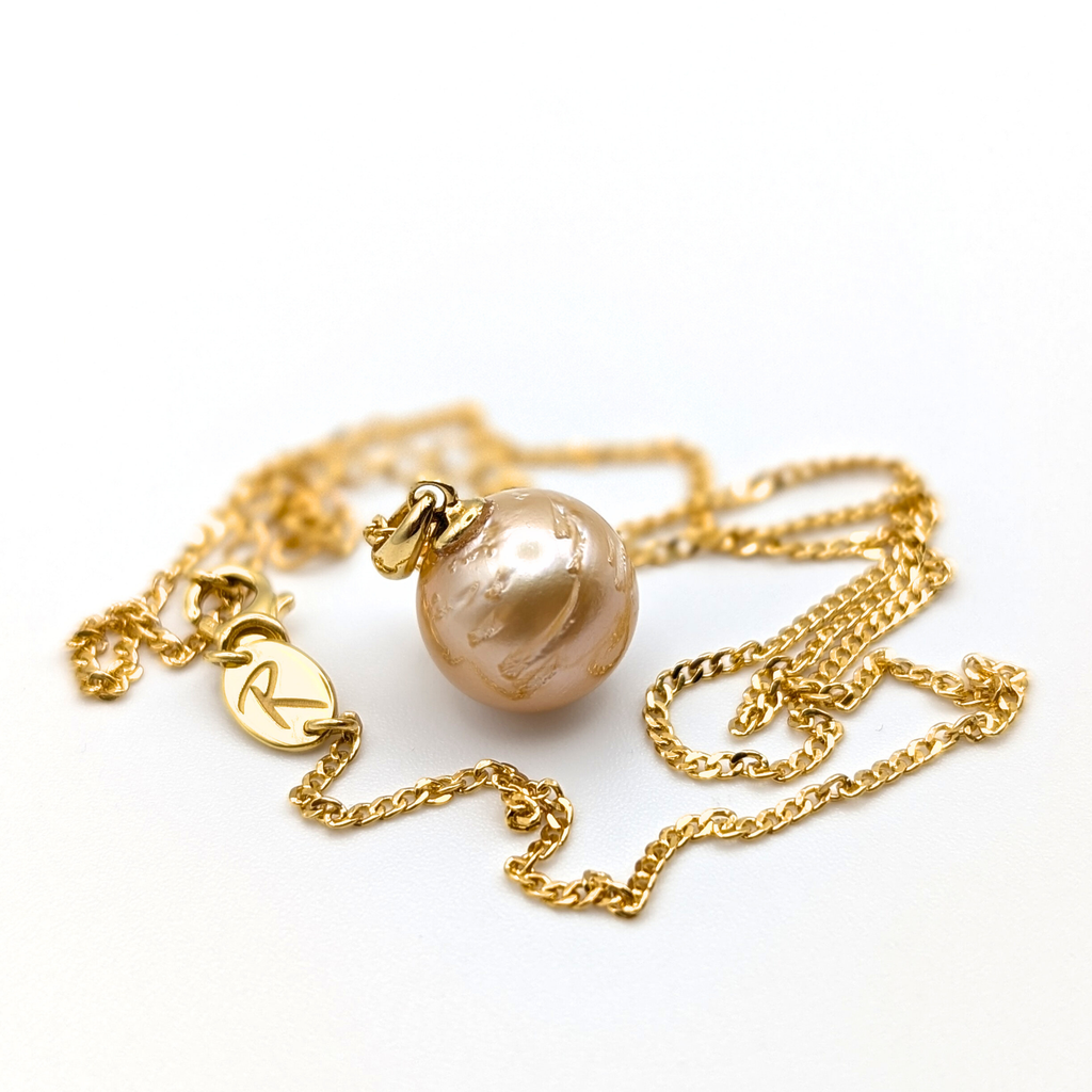 Gold vermeil necklace with a gold south sea pearl pendant on a white background