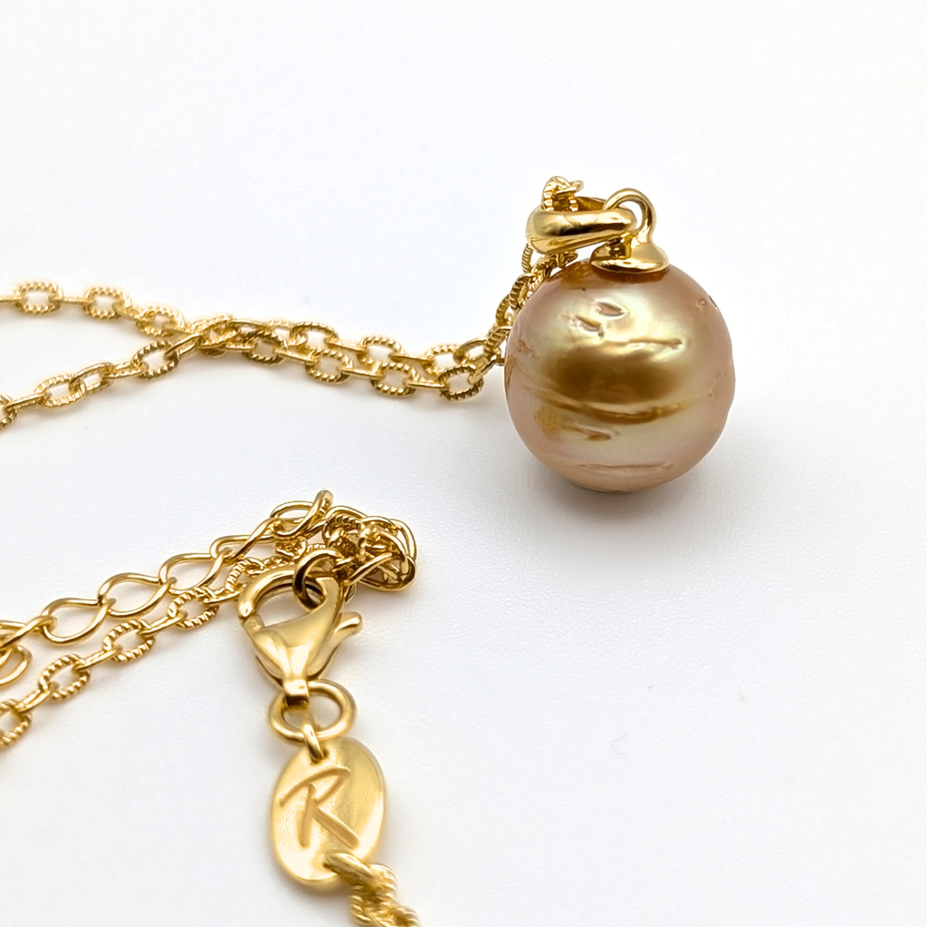Gold striped south sea pearl pendant necklace with gold vermeil necklace on a white background