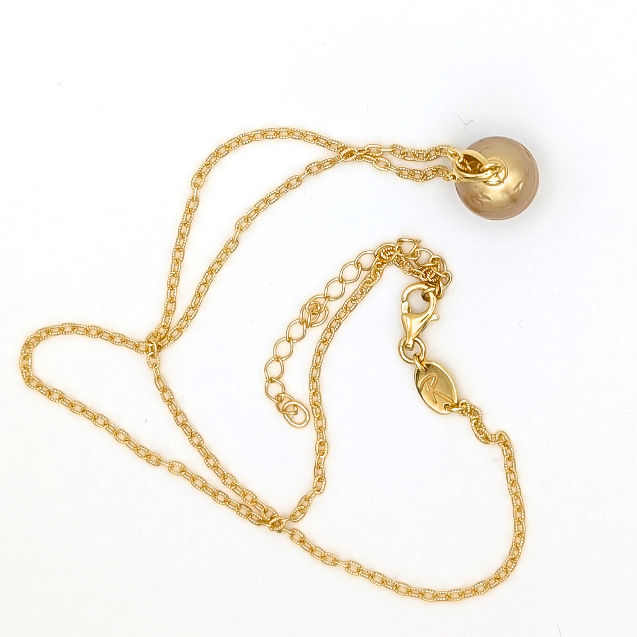 Gold striped south sea pearl pendant necklace with gold vermeil necklace on a white background