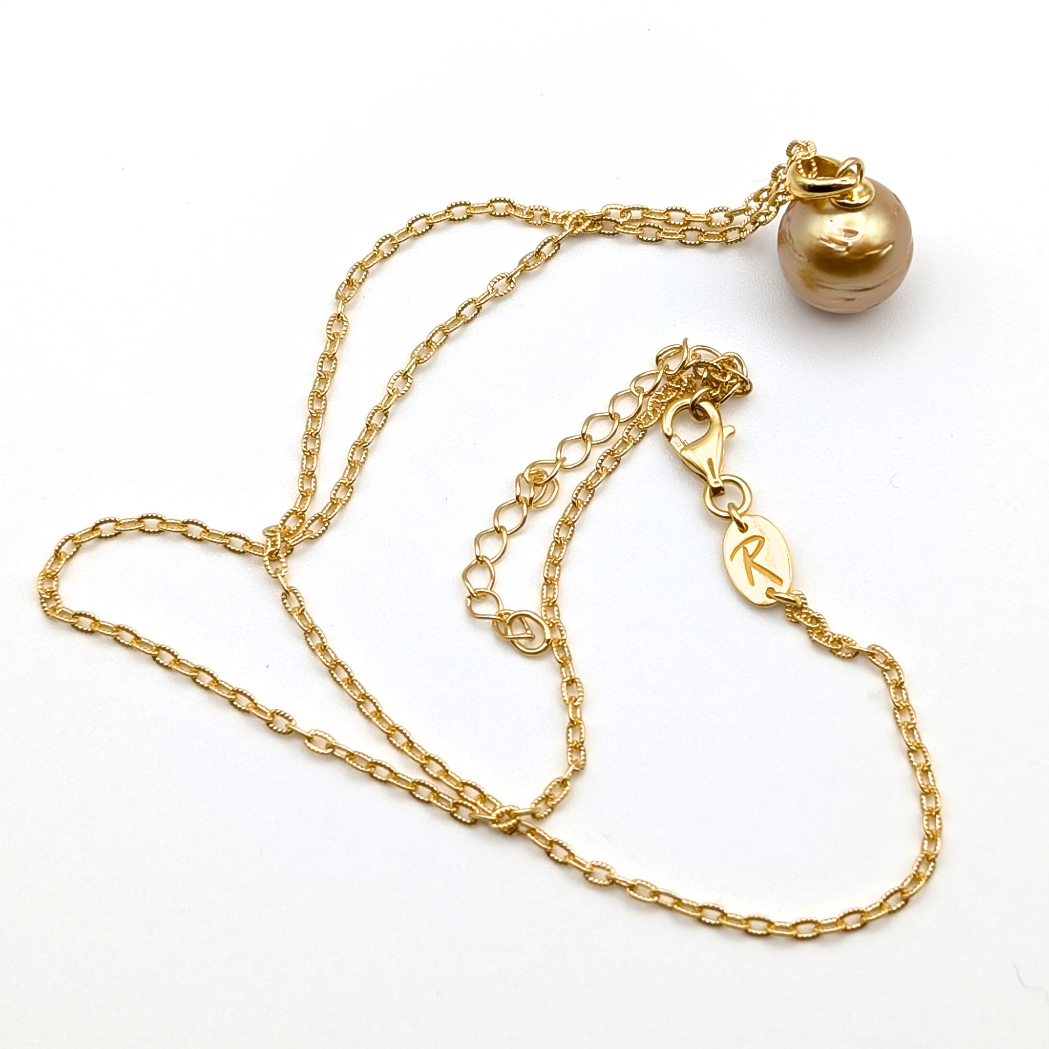 Gold striped south sea pearl pendant necklace with gold vermeil necklace on a white background