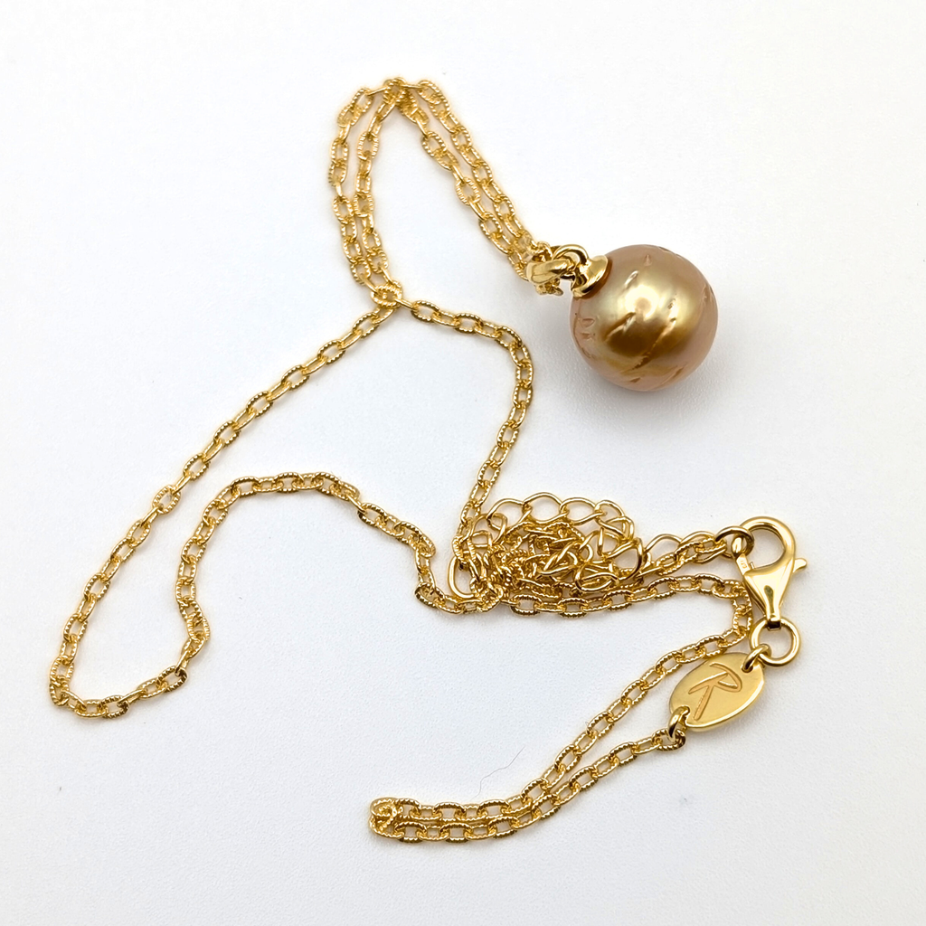 Gold striped south sea pearl pendant necklace with gold vermeil necklace on a white background