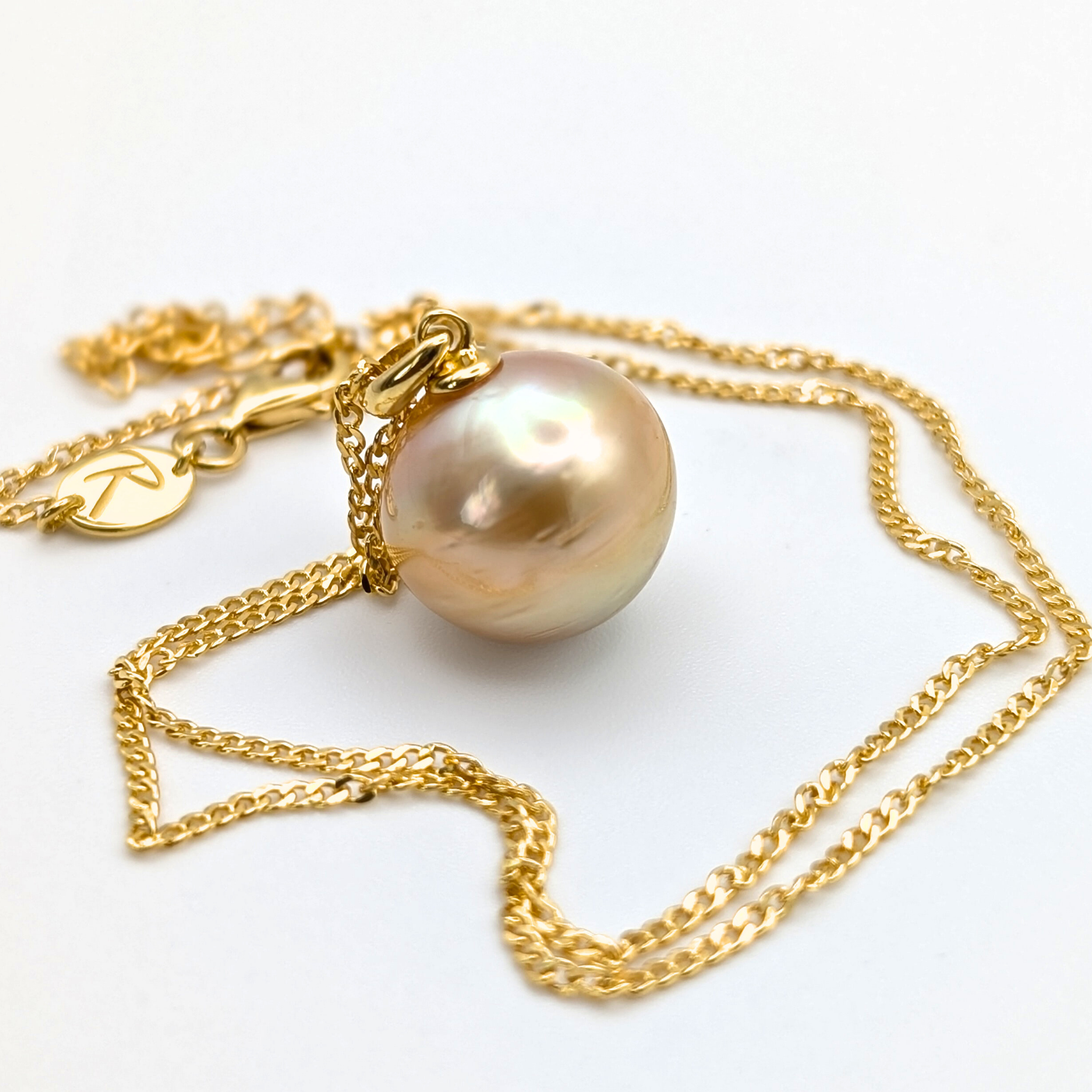 Gold vermeil necklace with an extra large south sea pearl pendant on a white background