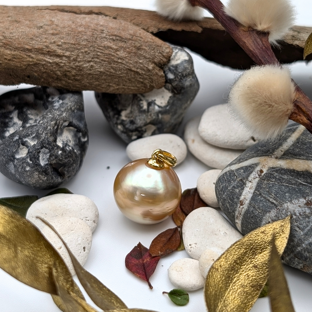 Gold vermeil necklace with an large south sea pearl pendant with lifestyle background 