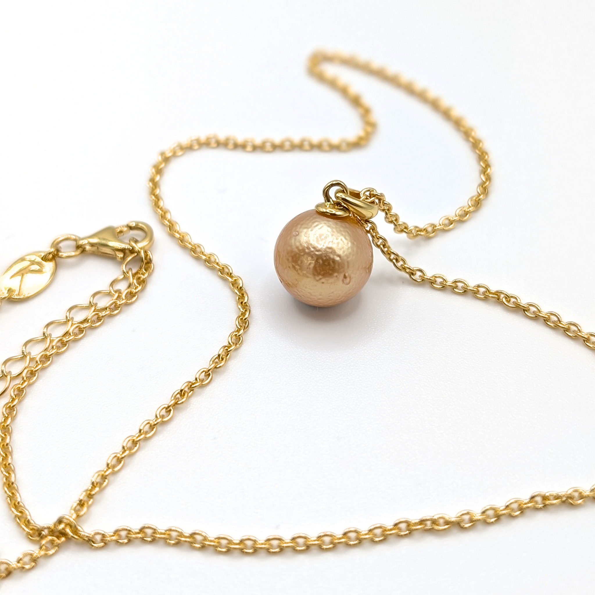 Gold South Sea pearl pendant necklace with Gold vermeil chain on a white background