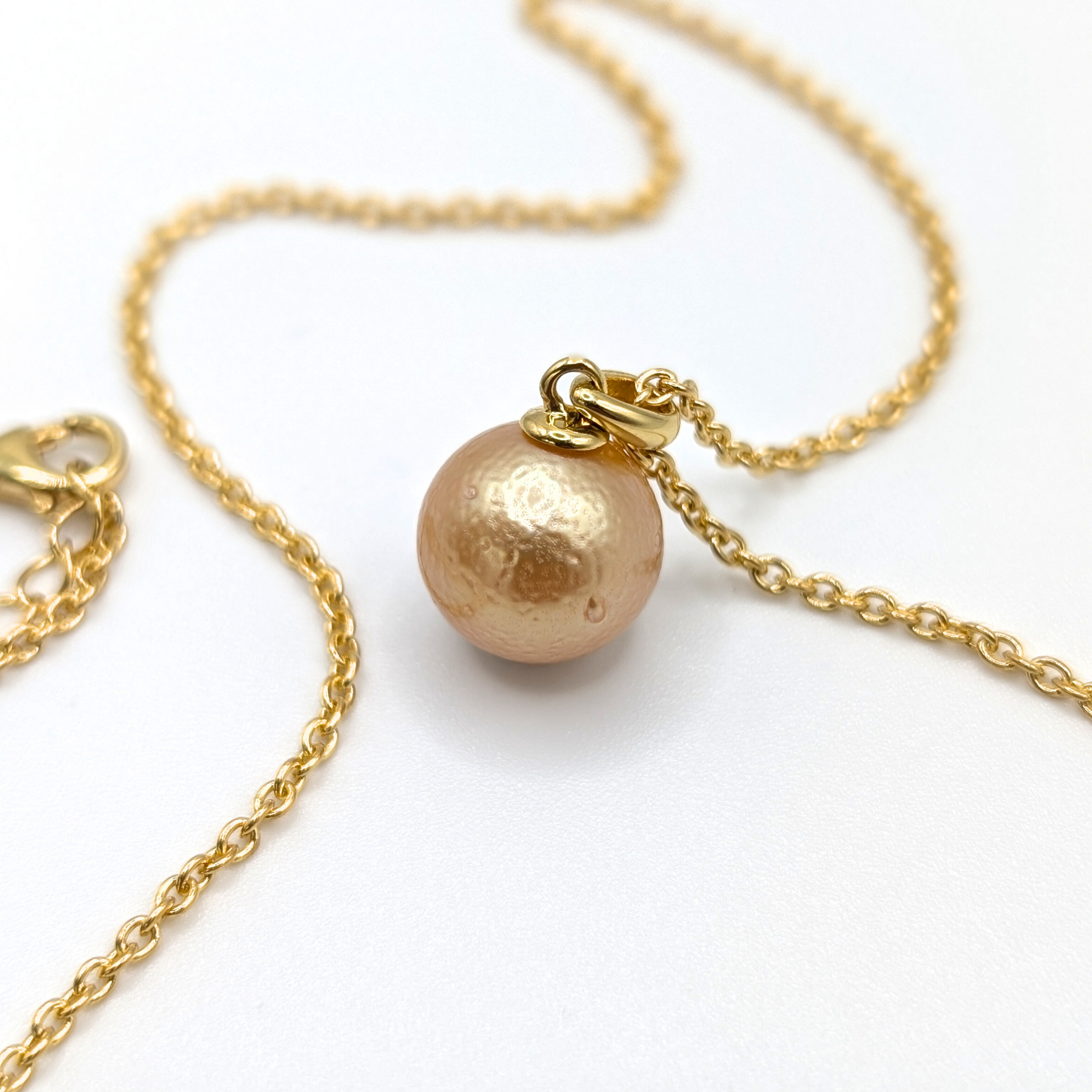Gold South Sea pearl pendant necklace with Gold vermeil chain on a white background