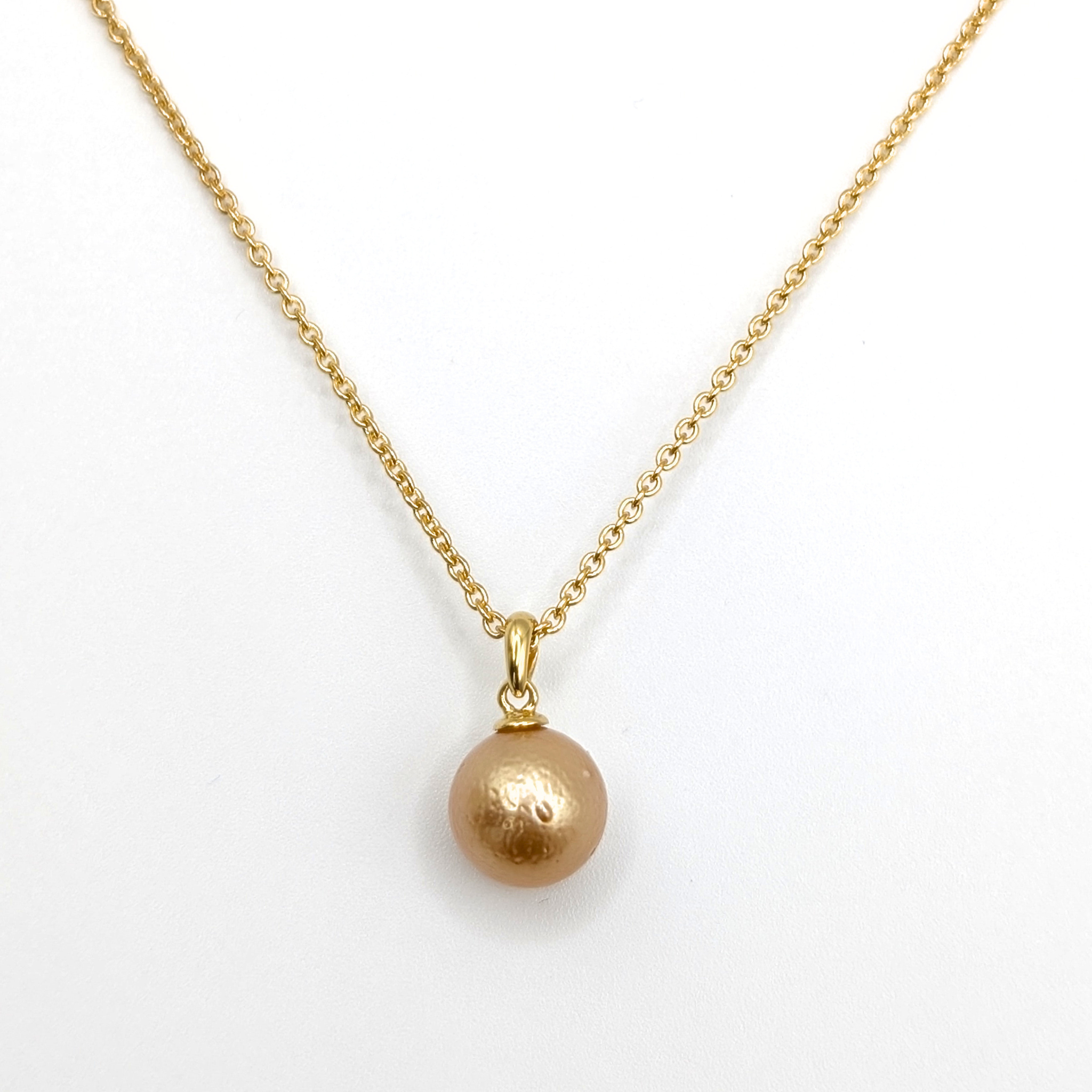 Gold South Sea pearl pendant necklace with Gold vermeil chain on a white background
