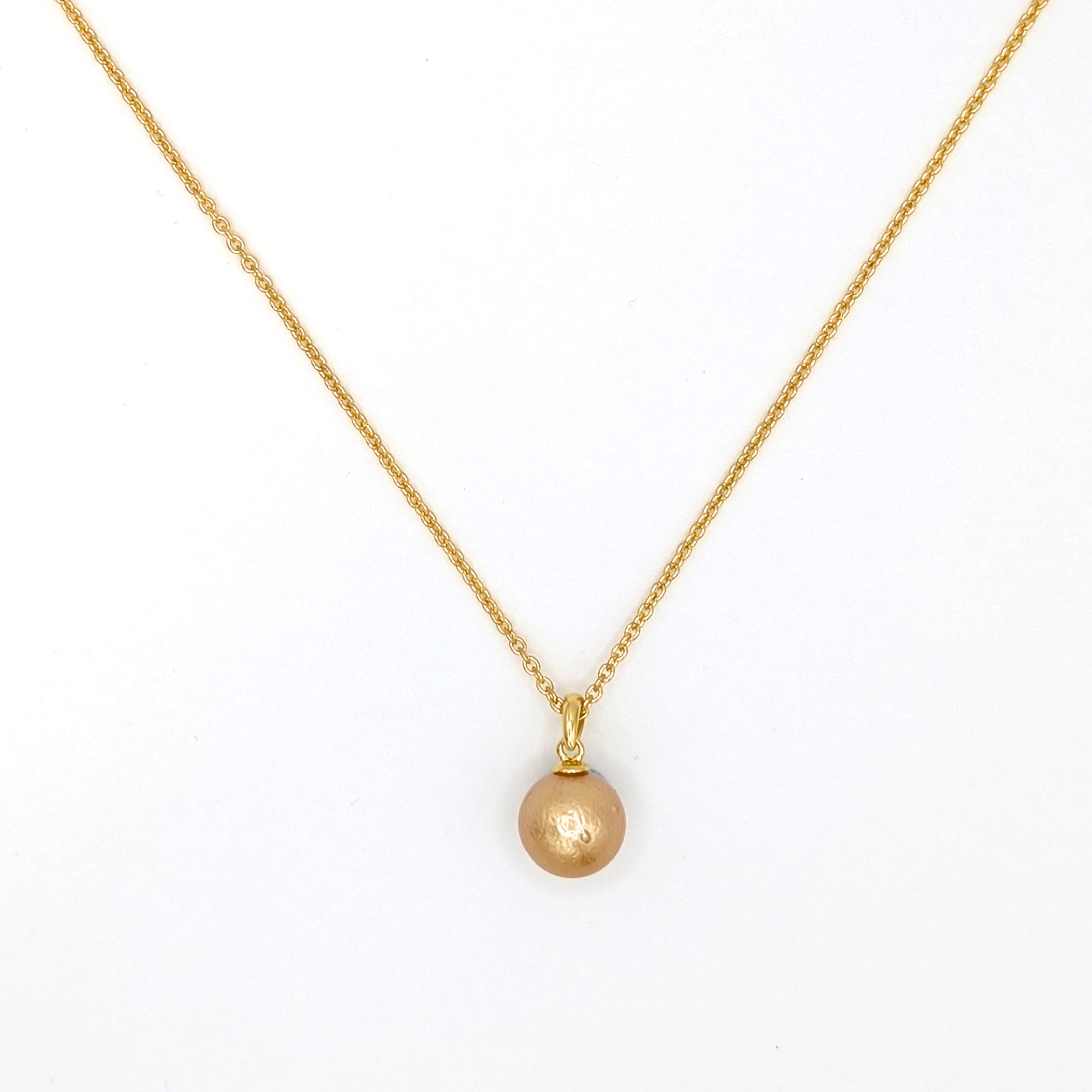 Gold South Sea pearl pendant necklace with Gold vermeil chain on a white background