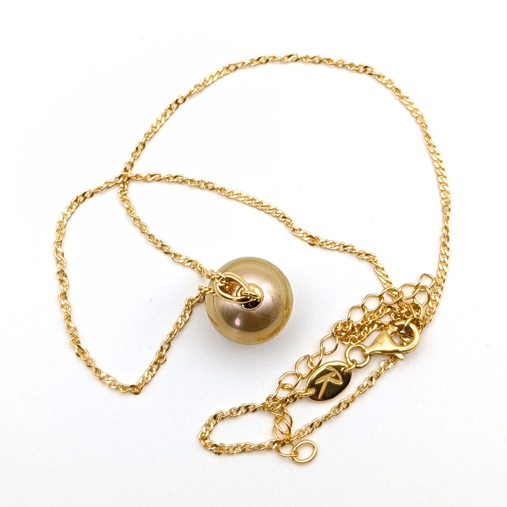 Gold necklace with a large gold south sea pearl pendant on a white background