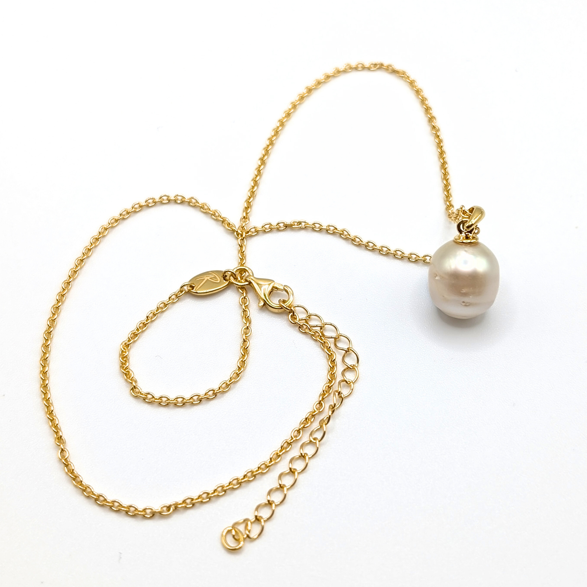 Gold south sea pearl pendant necklace with gold vermeil chain on a white background