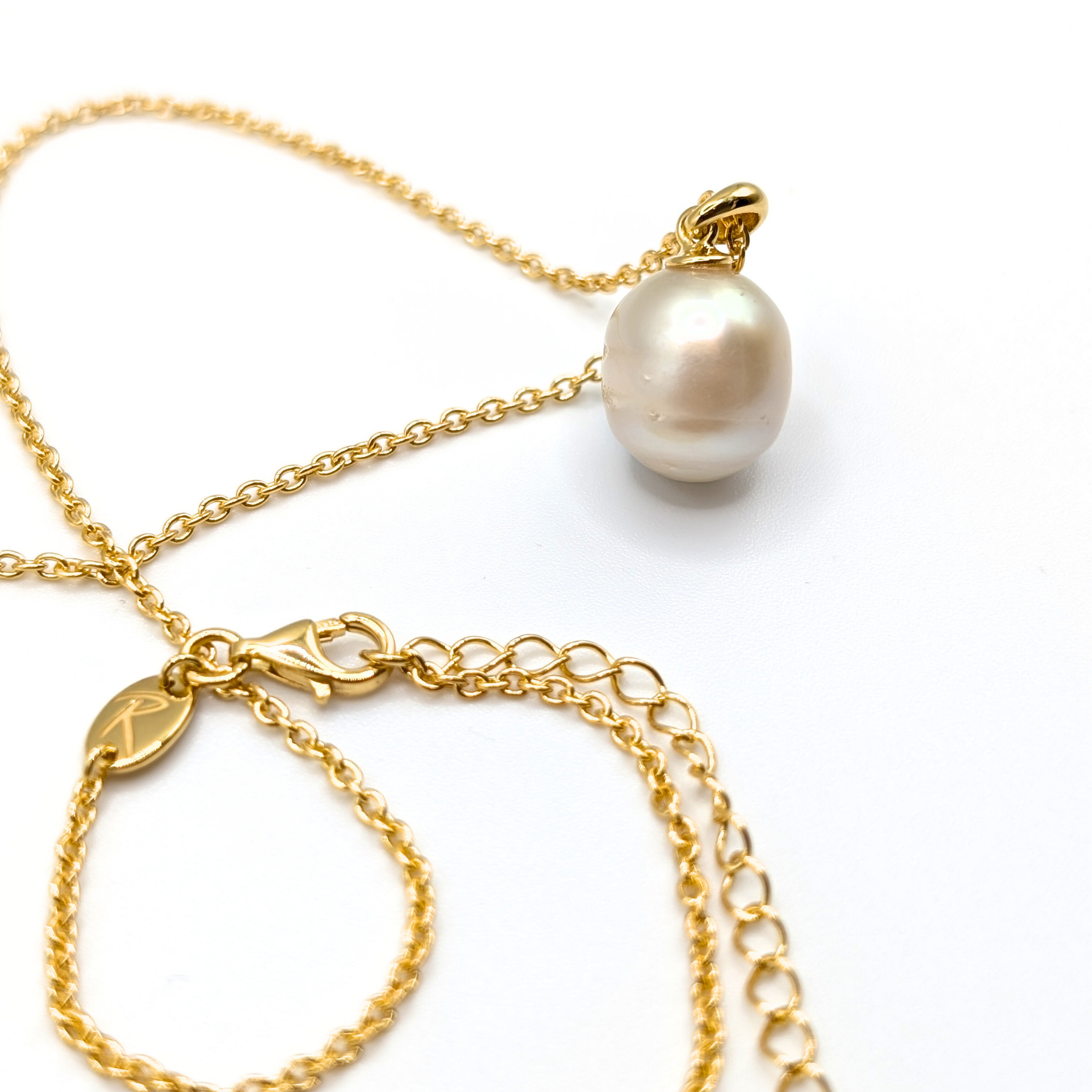 Gold south sea pearl pendant necklace with gold vermeil chain on a white background