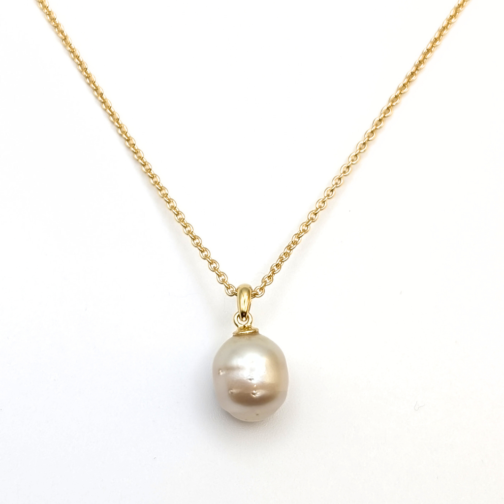 Gold south sea pearl pendant necklace with gold vermeil chain on a white background