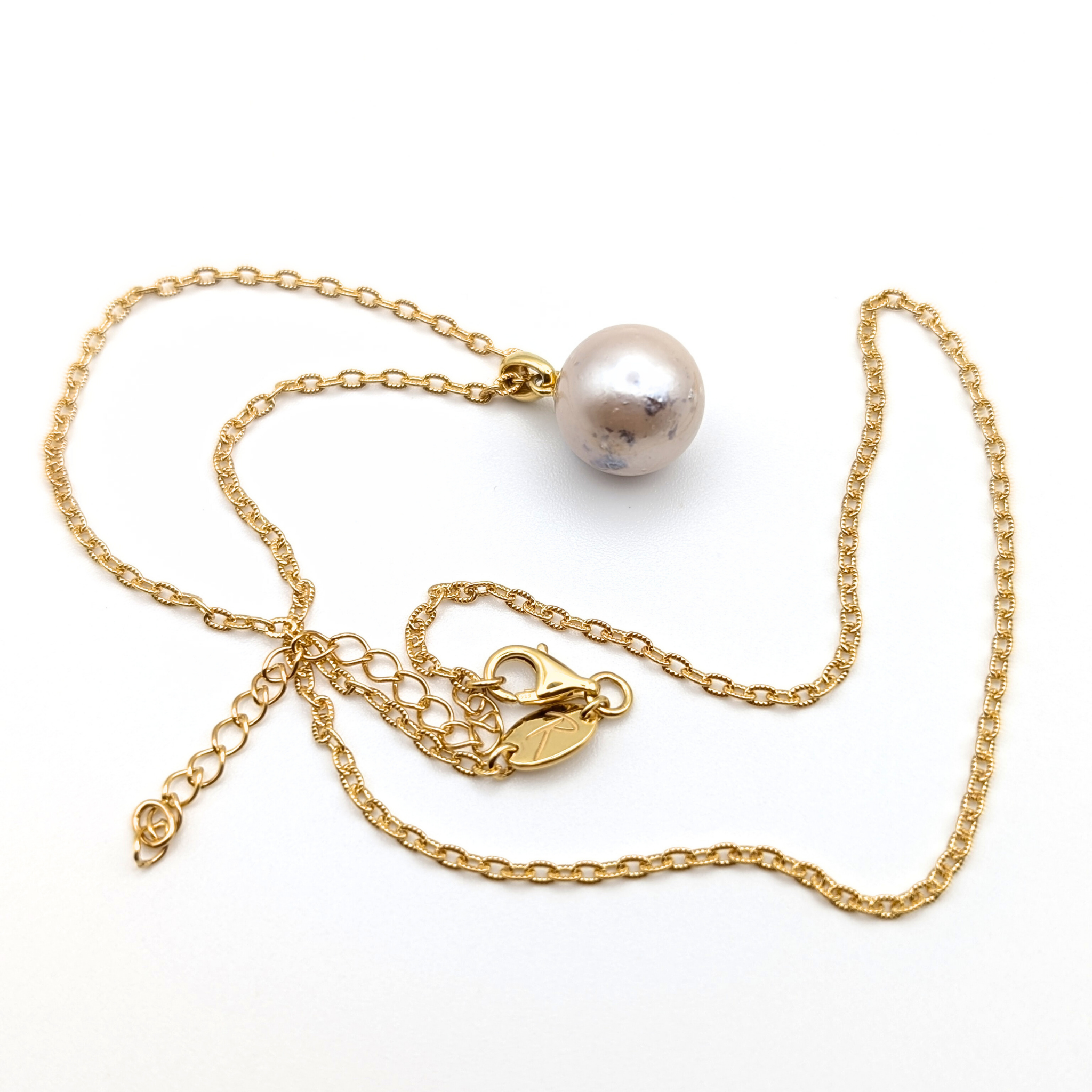 large pink south sea pearl pendant necklace with a gold vermeil chain on a white background