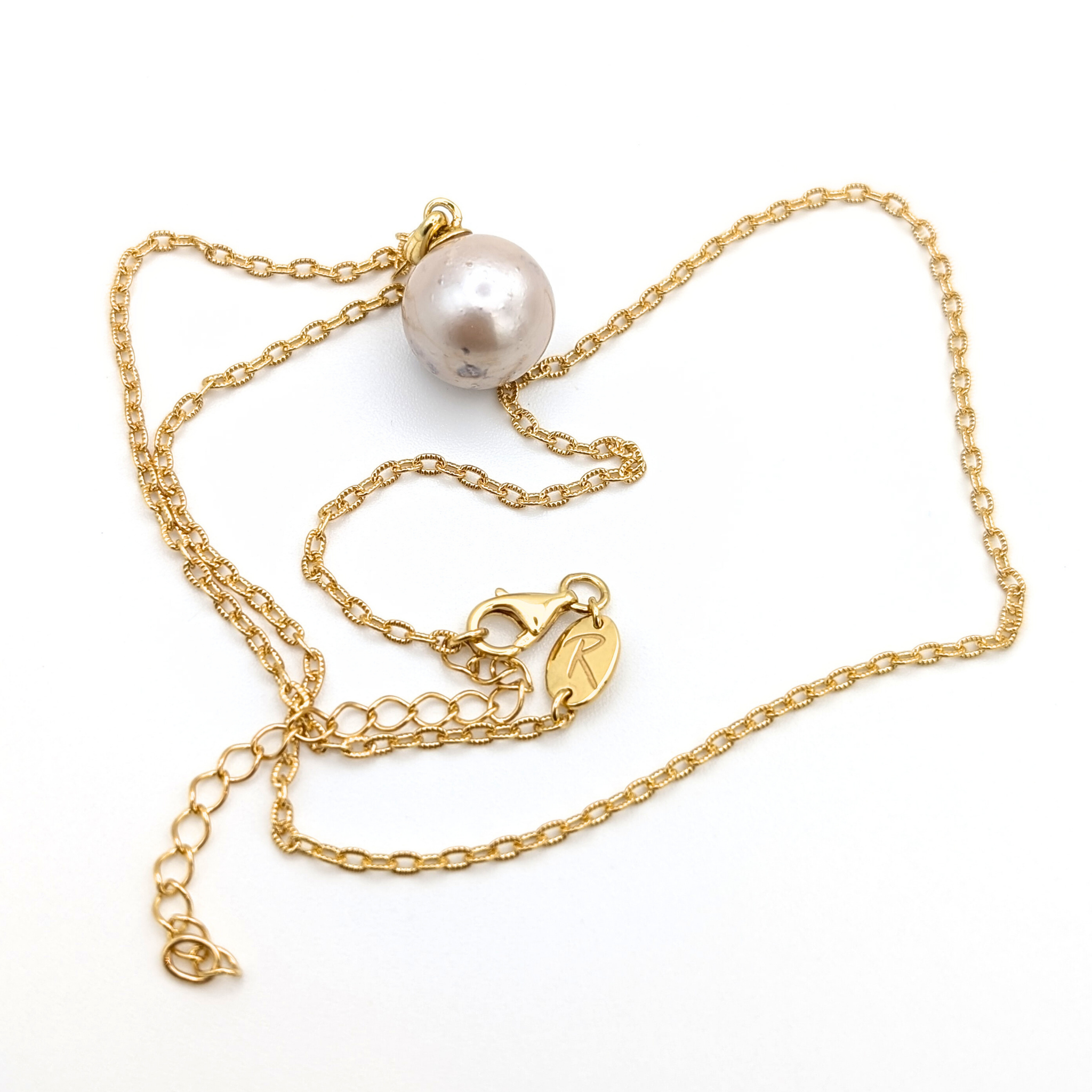 large pink south sea pearl pendant necklace with a gold vermeil chain on a white background