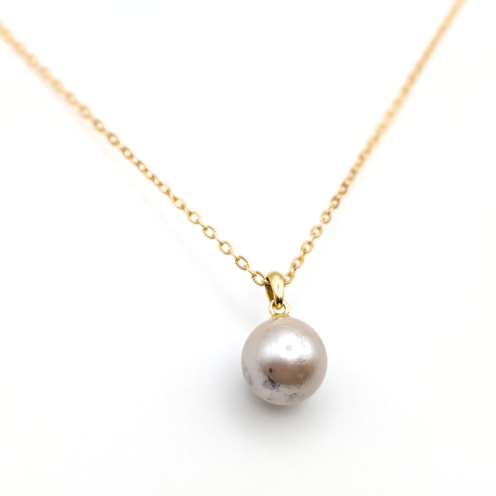 large pink south sea pearl pendant necklace with a gold vermeil chain on a white background