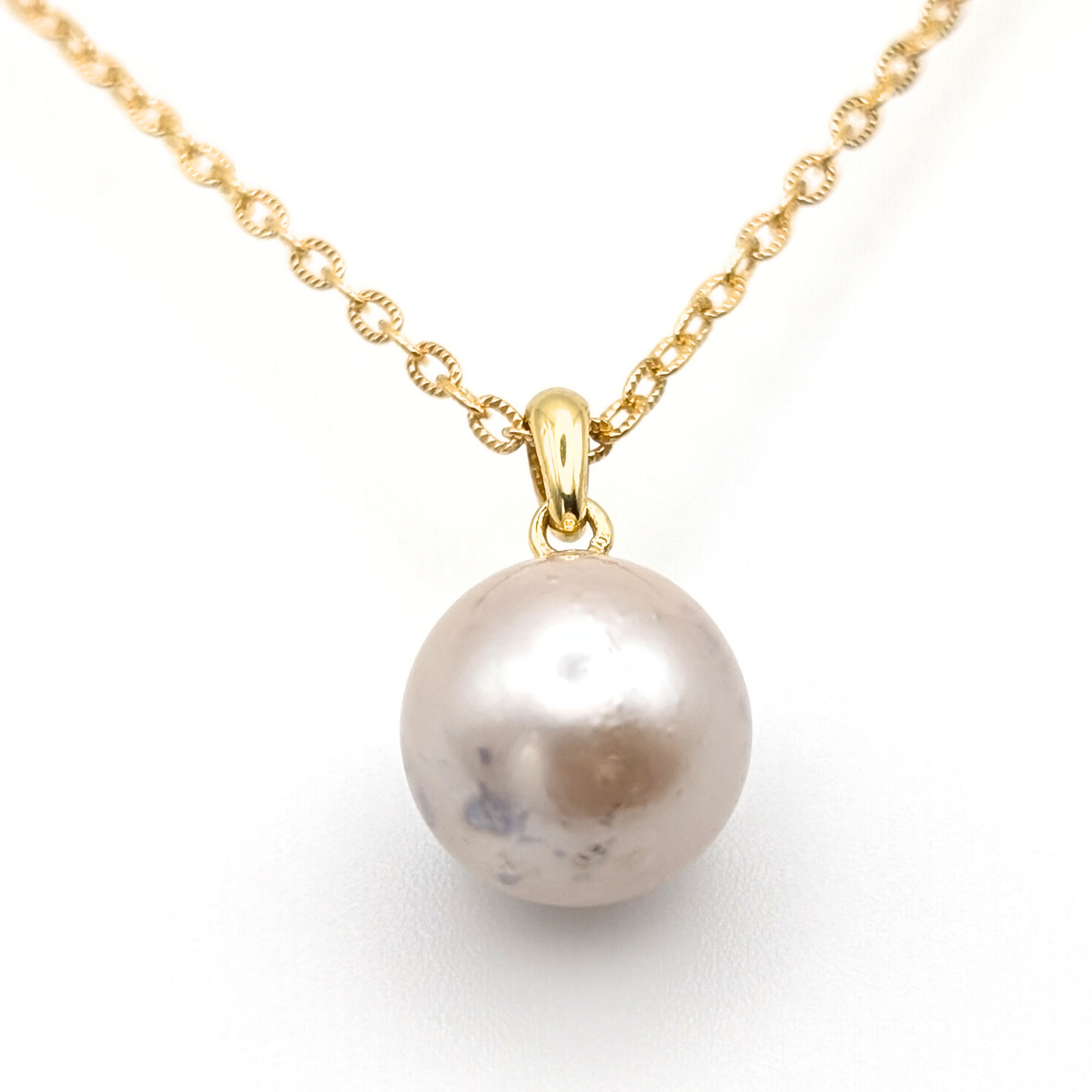 large pink south sea pearl pendant necklace with a gold vermeil chain on a white background