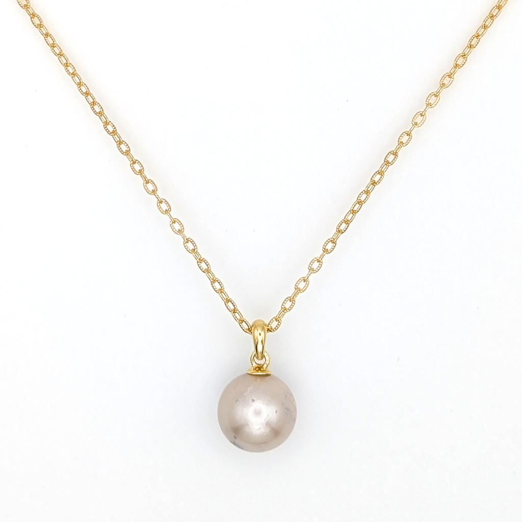 large pink south sea pearl pendant necklace with a gold vermeil chain on a white background