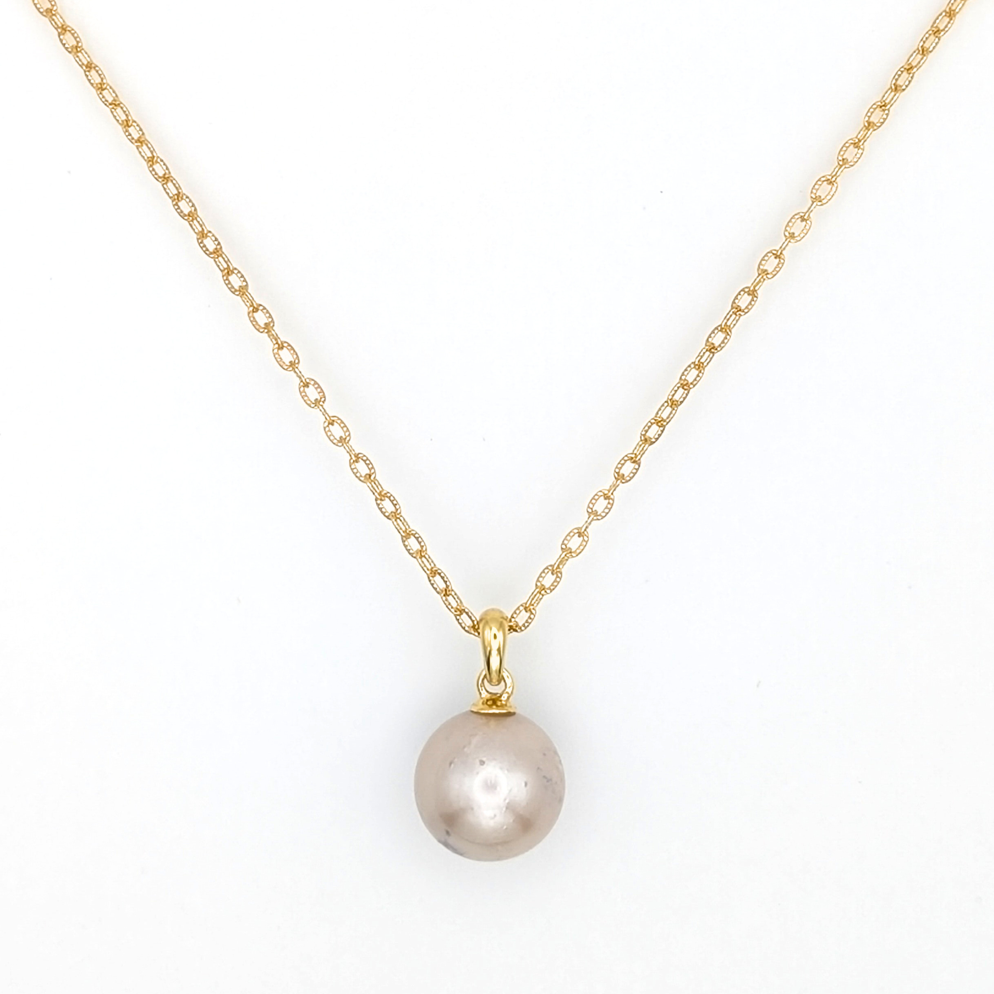 large pink south sea pearl pendant necklace with a gold vermeil chain on a white background