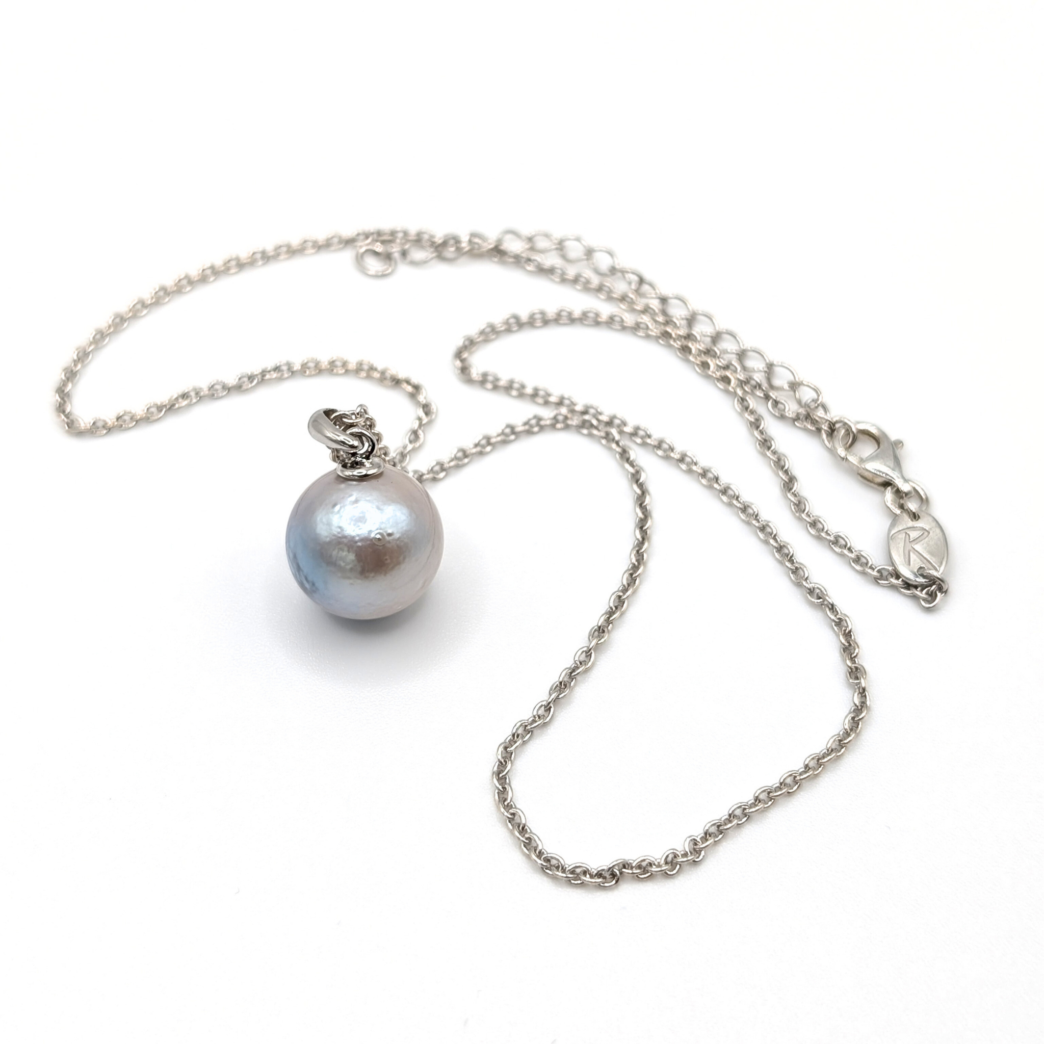 Pearl necklace with silver chain on a white background