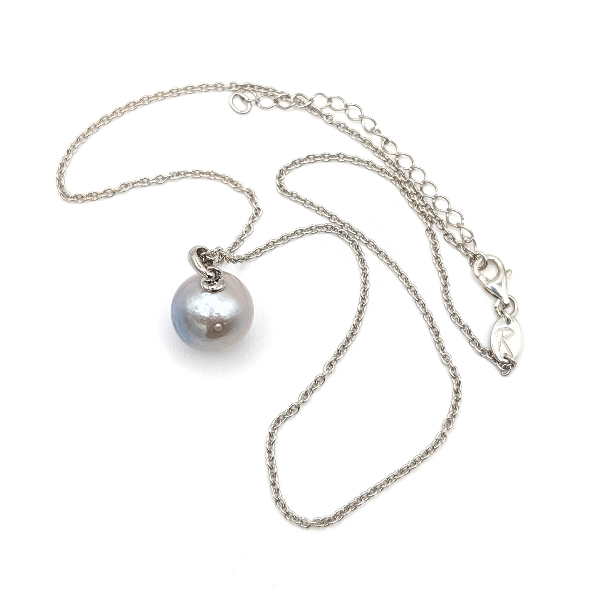 Pearl necklace with a silver chain on a white background
