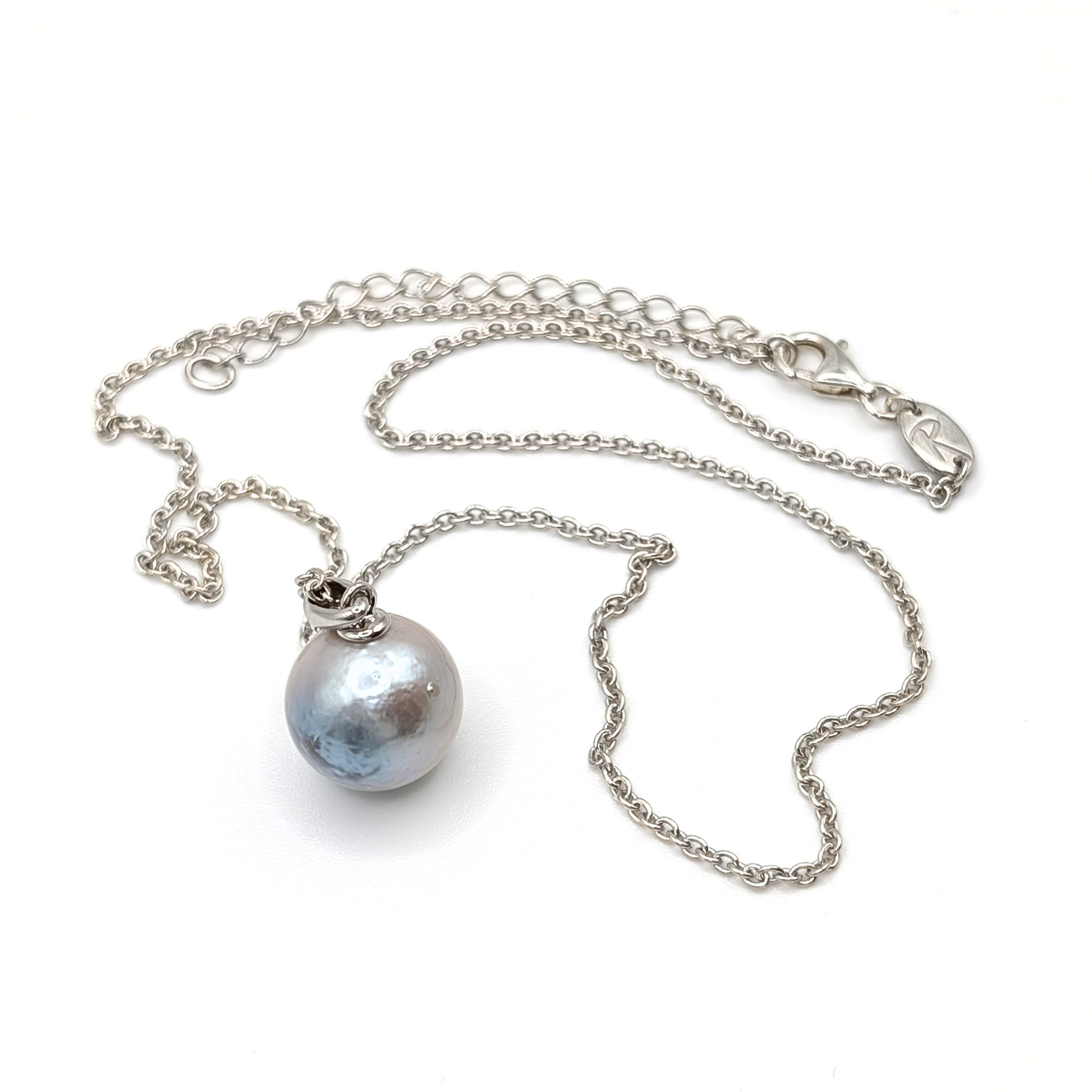 Silver necklace with a large pearl pendant on a white background
