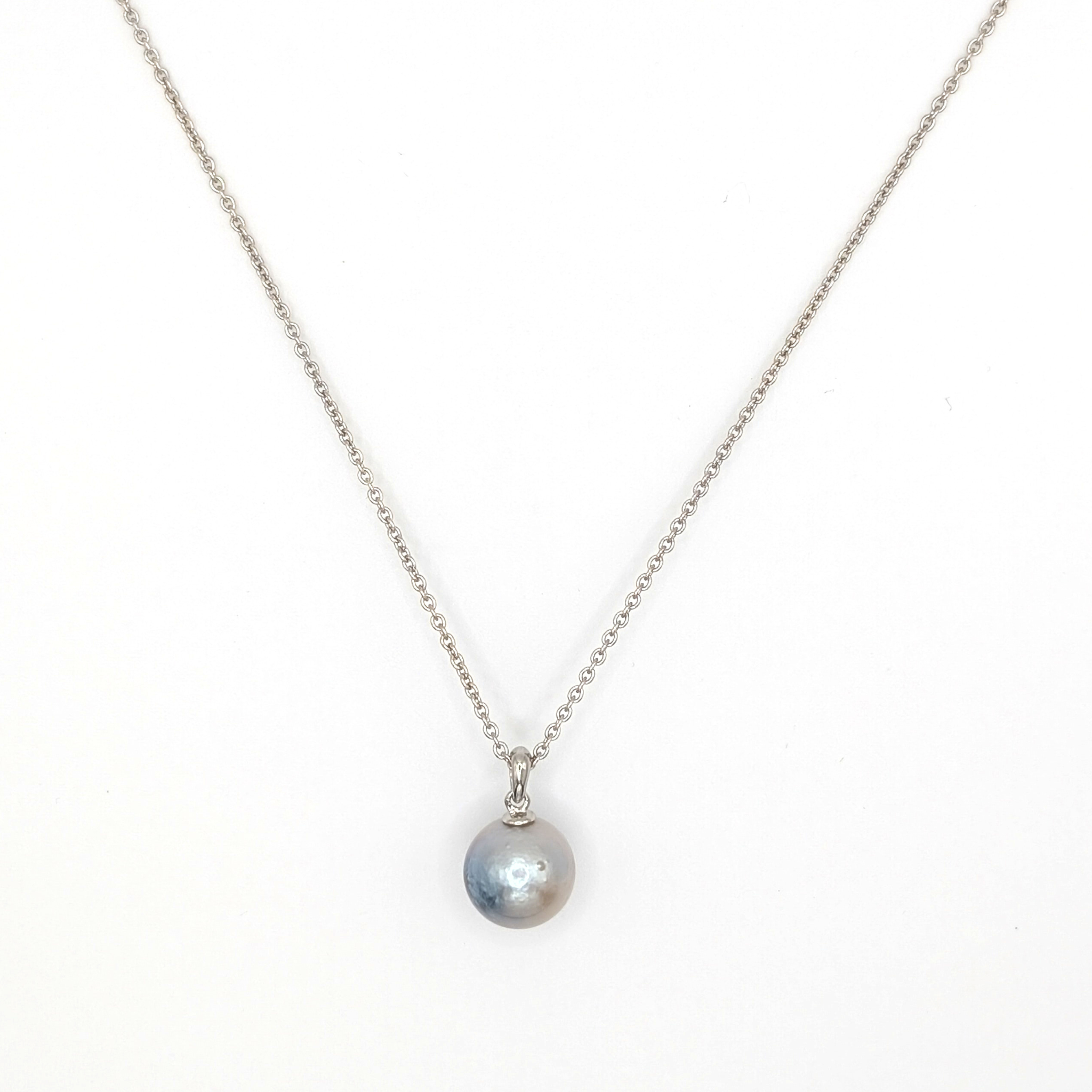 Necklace with a single pearl pendant on a white background