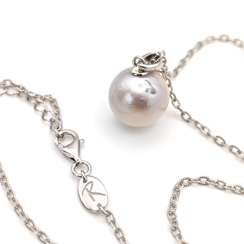 Silver south sea pearl pendant necklace with rhodium plated silver chain on a white background