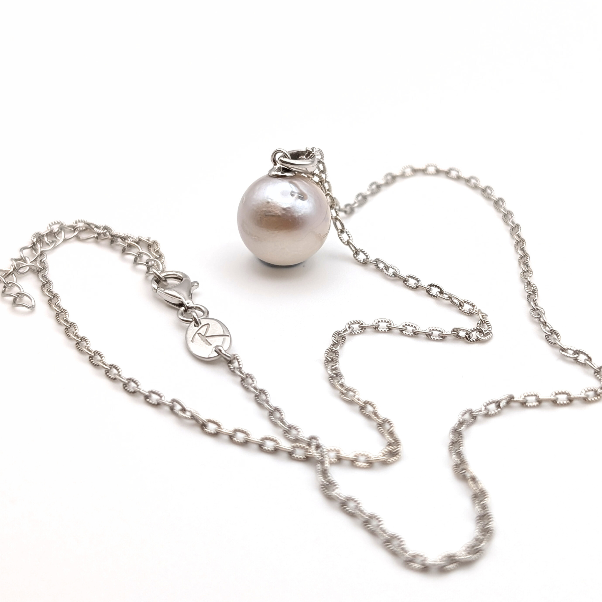 Silver south sea pearl pendant necklace with rhodium plated silver chain on a white background