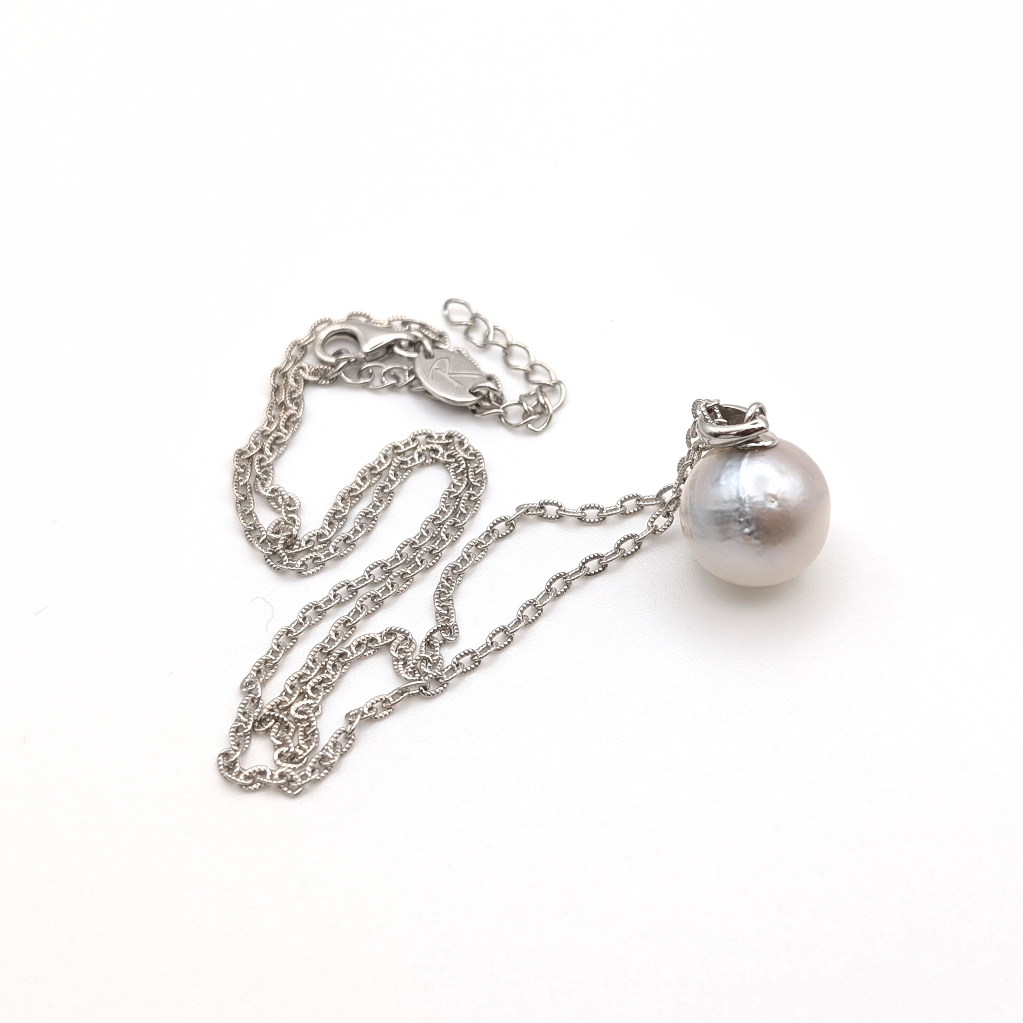 Silver south sea pearl pendant necklace with rhodium plated silver chain on a white background