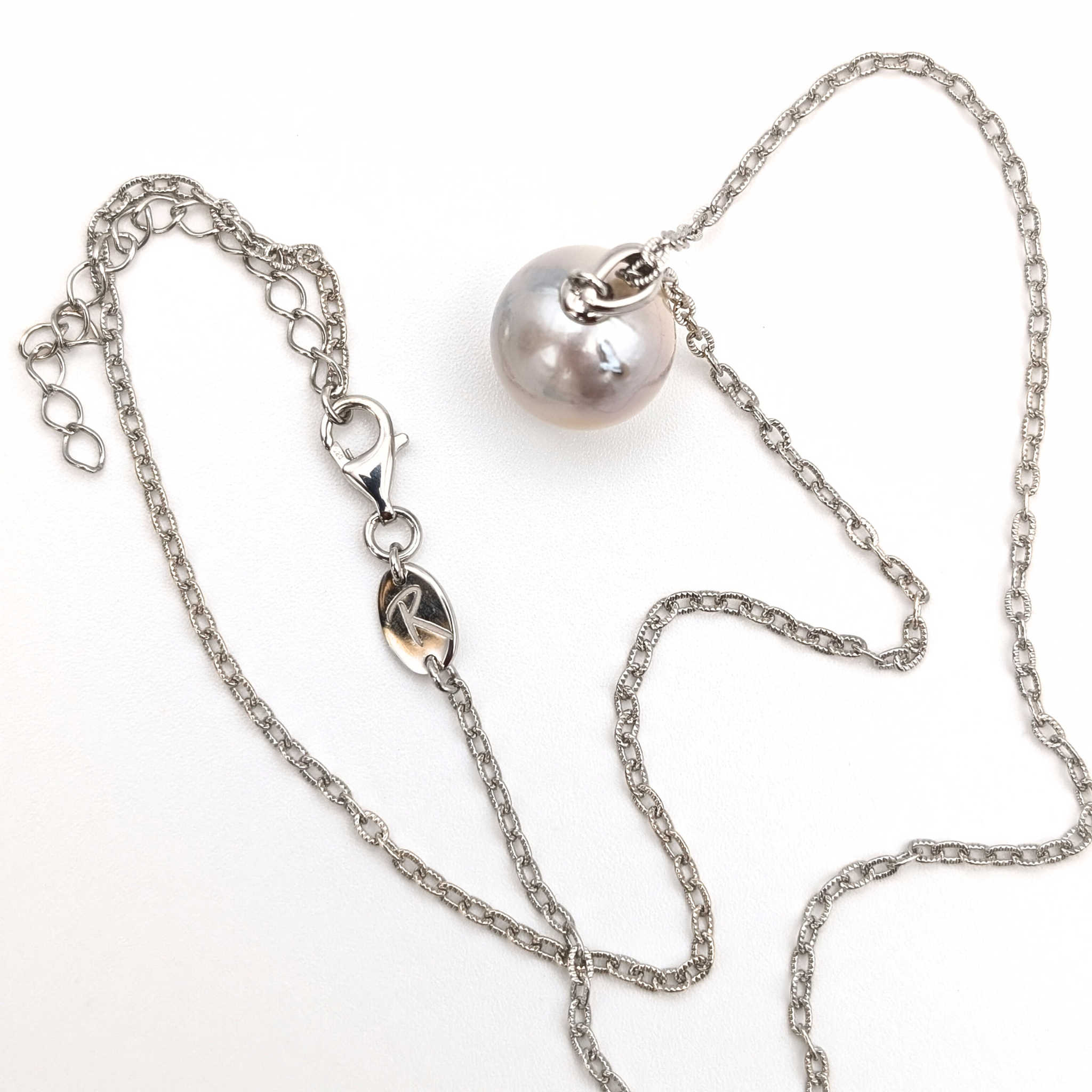 Silver south sea pearl pendant necklace with rhodium plated silver chain on a white background