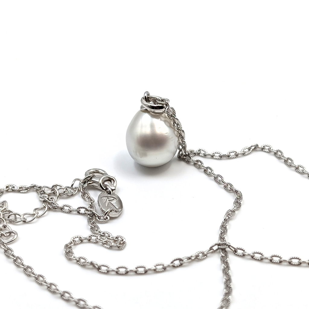 Silver teardrop shaped south sea pearl pendant on a rhodium plated sterling silver chain with a white background
