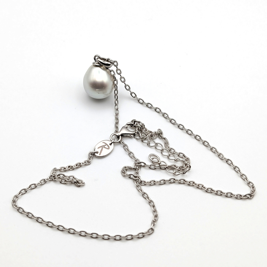 Silver teardrop shaped south sea pearl pendant on a rhodium plated sterling silver chain with a white background
