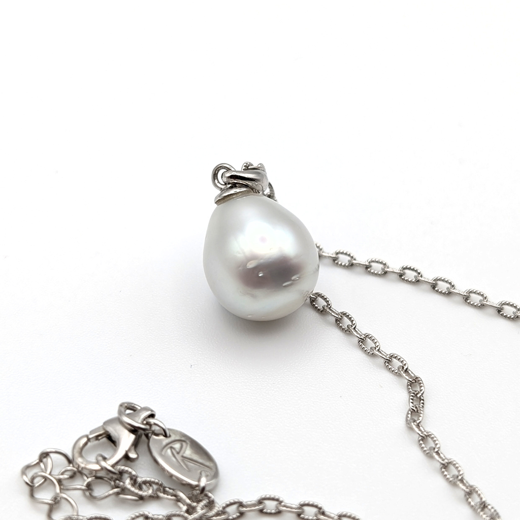 Silver teardrop shaped south sea pearl pendant on a rhodium plated sterling silver chain with a white background