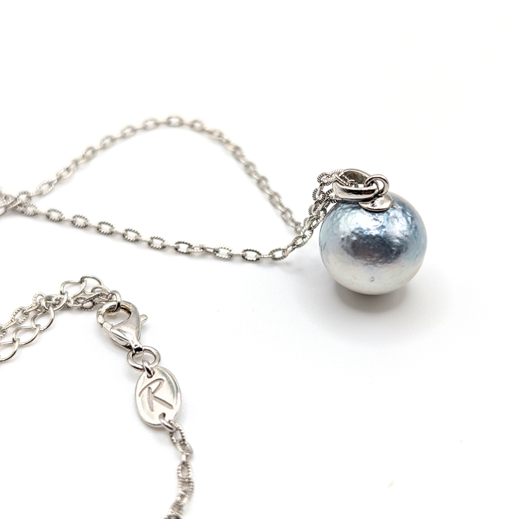 Necklace with a single silver south sea  pearl pendant on rhodium plated chain with a white background
