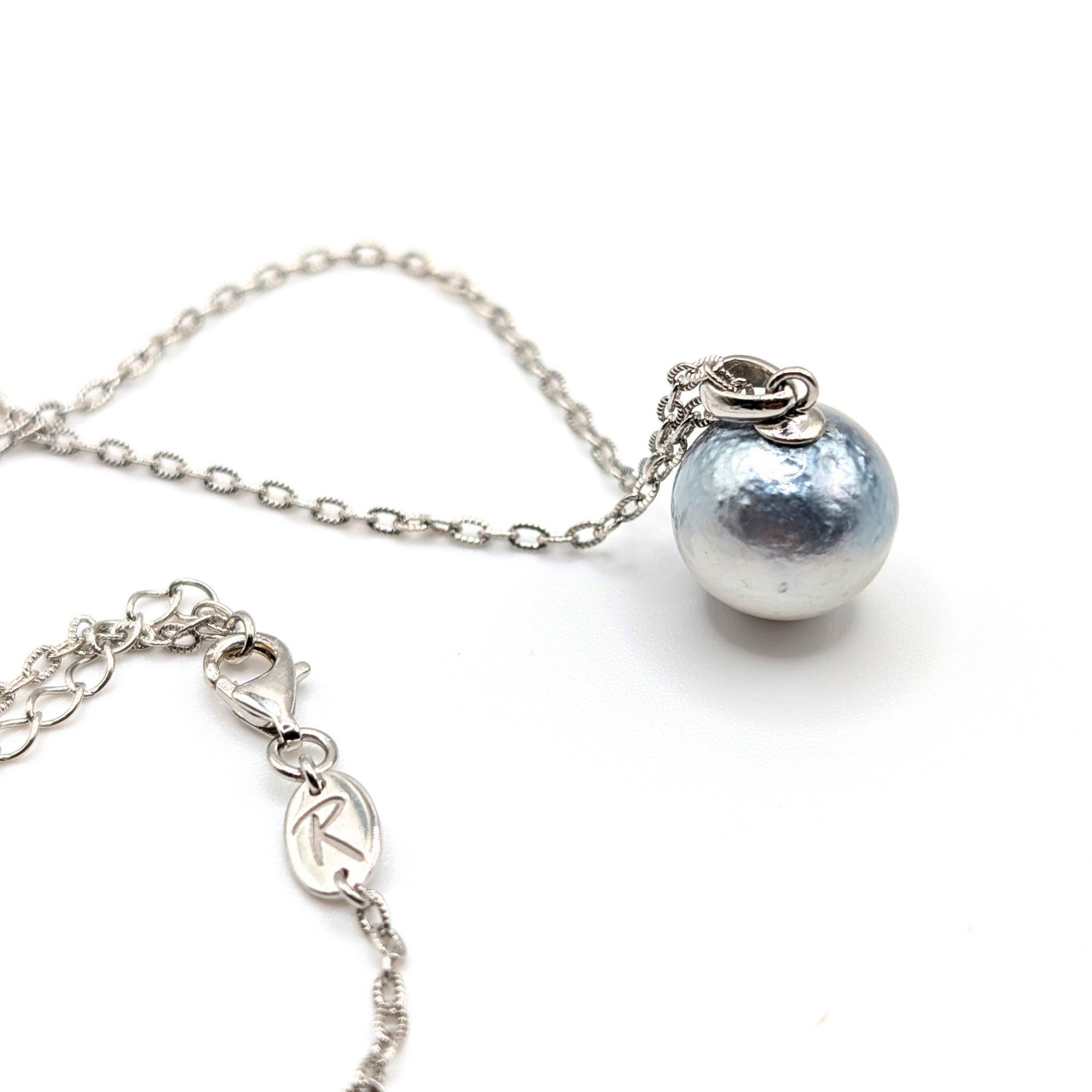 Necklace with a single silver south sea  pearl pendant on rhodium plated chain with a white background