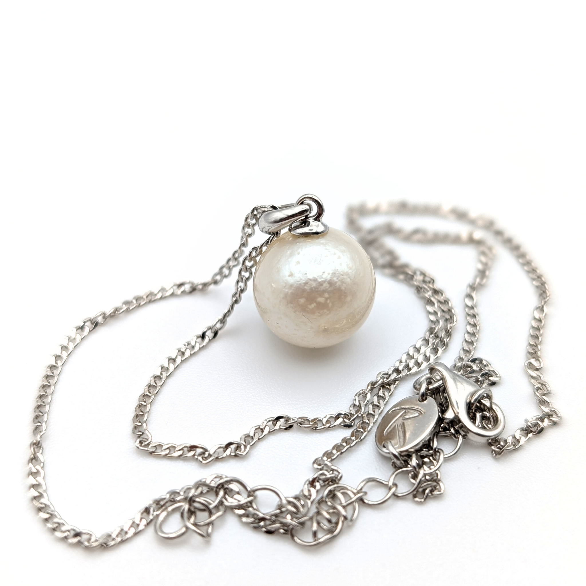 Rhodium plated sterling Silver necklace with a south sea  pearl pendant on a white background