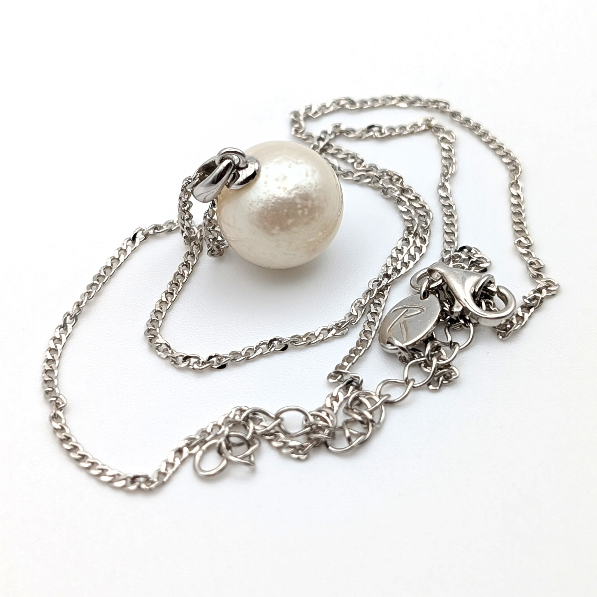Rhodium plated sterling Silver necklace with a south sea  pearl pendant on a white background