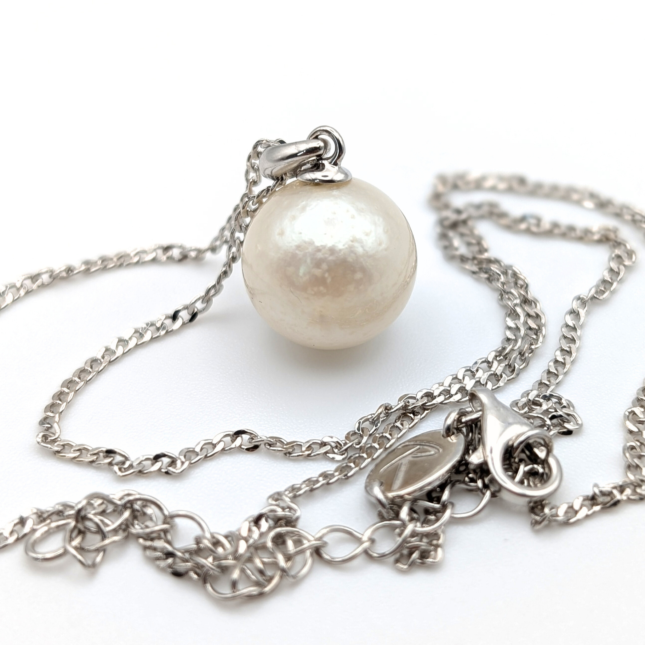 Rhodium plated sterling Silver necklace with a south sea  pearl pendant on a white background