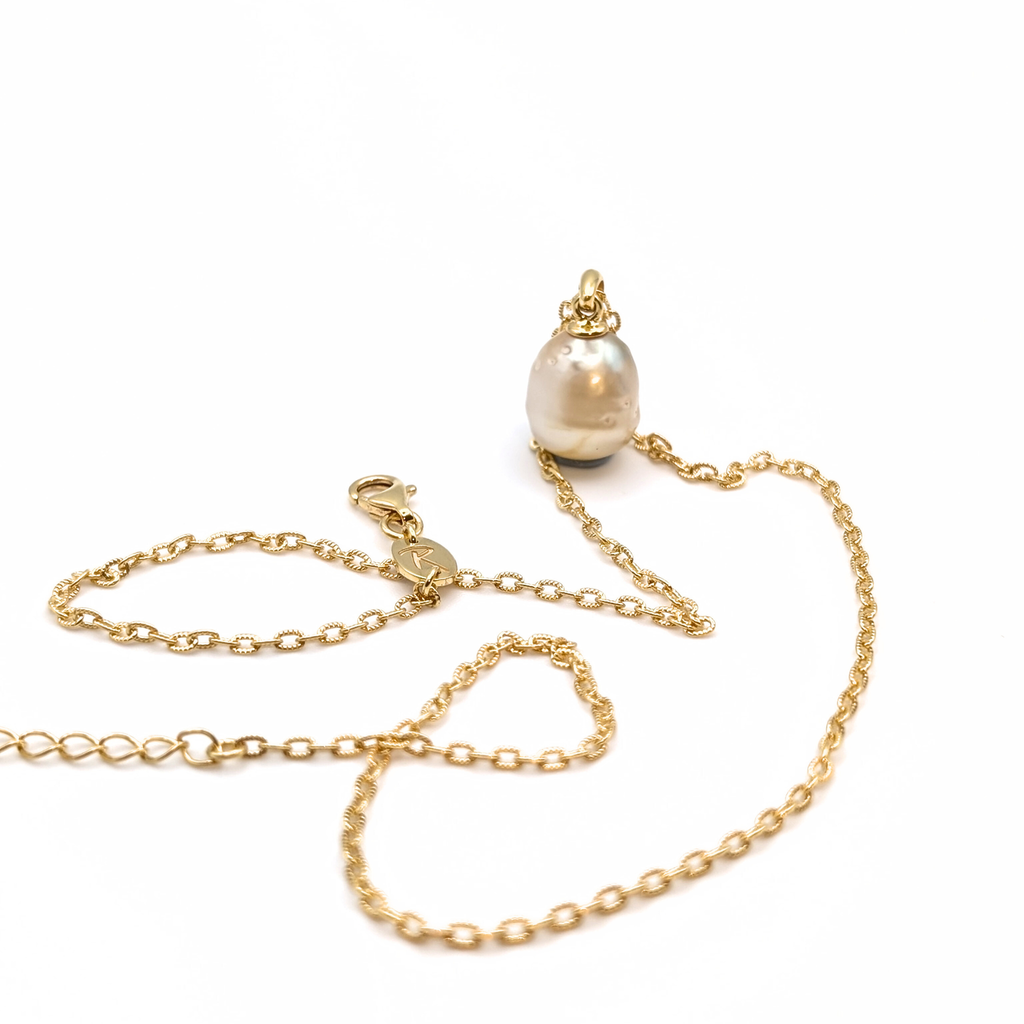 Gold vermeil pendant necklace with a gold spotted south sea pearl pendant on a white background