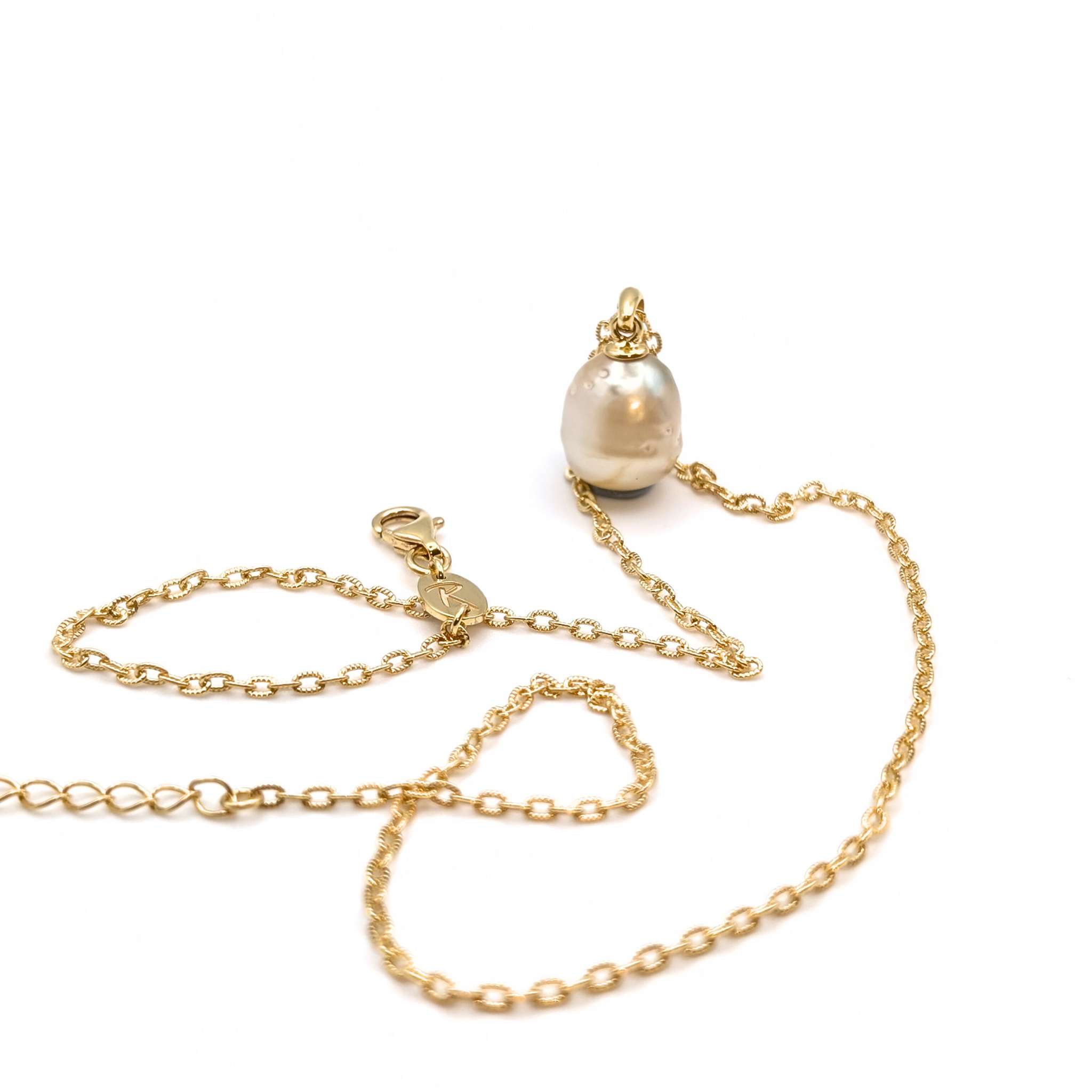Gold vermeil pendant necklace with a gold spotted south sea pearl pendant on a white background