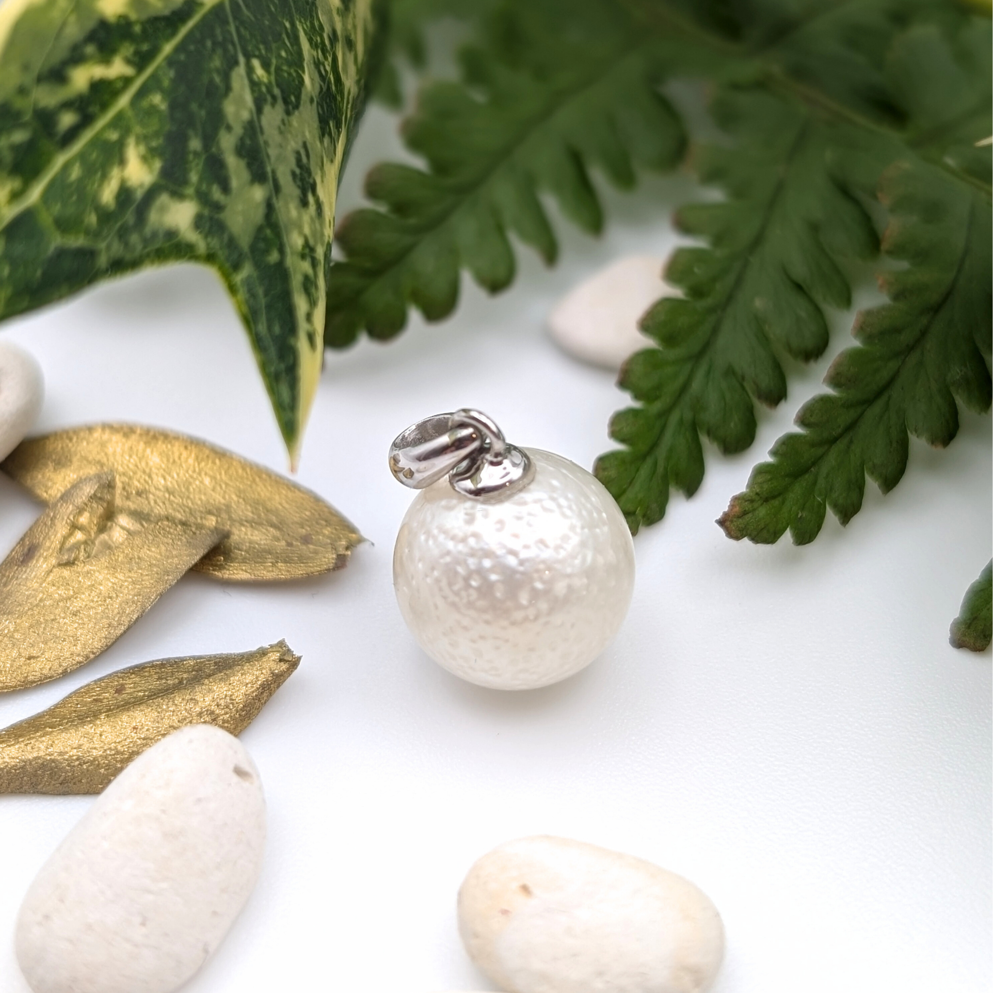 Spotted large white south sea pearl pendant necklace with rhodium plated sterling silver chain lifestyle background