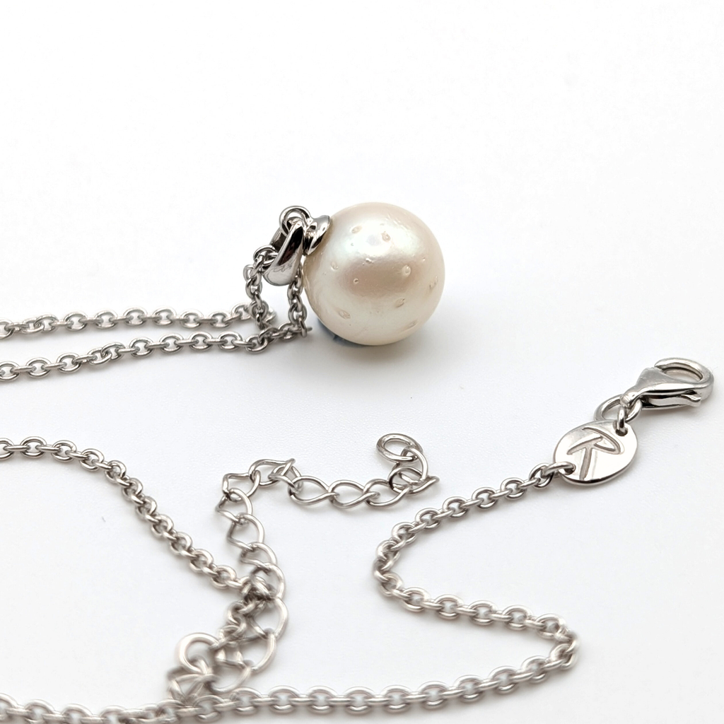 Spotted large white  south sea pearl pendant necklace with rhodium plated sterling silver chain on white background