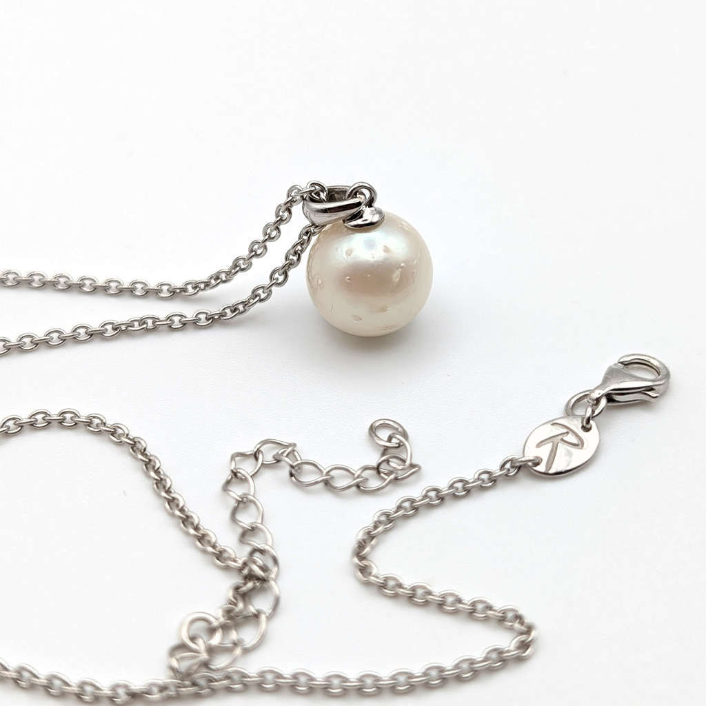 Spotted large white  south sea pearl pendant necklace with rhodium plated sterling silver chain on white background
