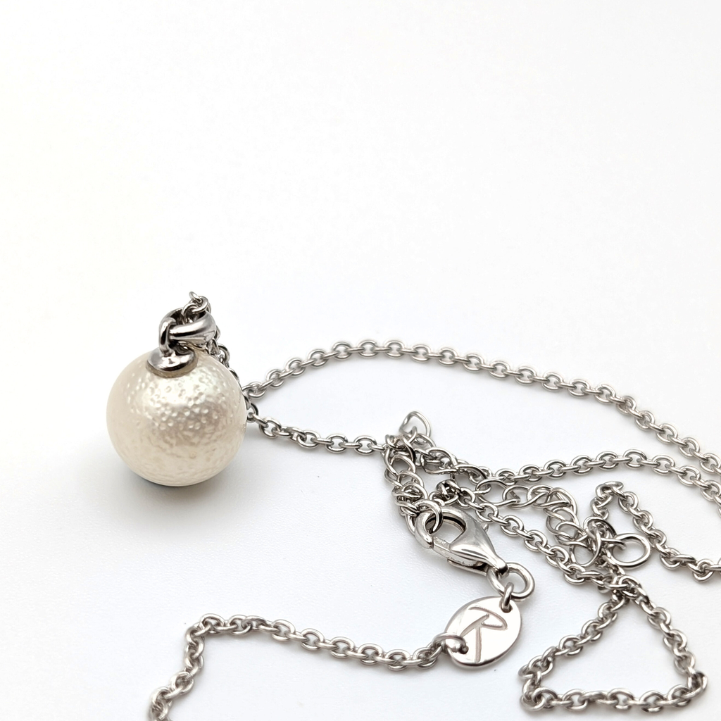 Spotted large white south sea pearl pendant necklace with rhodium plated sterling silver chain on white background