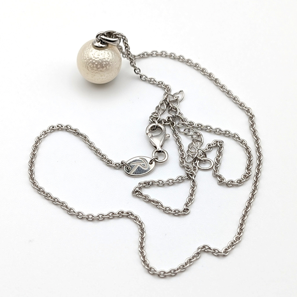 Spotted large white south sea pearl pendant necklace with rhodium plated sterling silver chain on white background