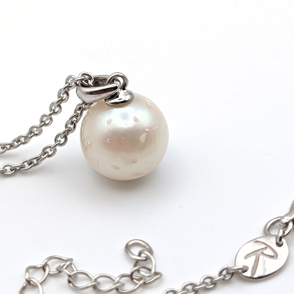 Spotted large white  south sea pearl pendant necklace with rhodium plated sterling silver chain on white background